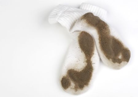 Really dirty white socks worn by a toddler outside.の写真素材