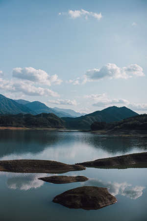 mountain lake under blue sky and white cloudsの写真素材