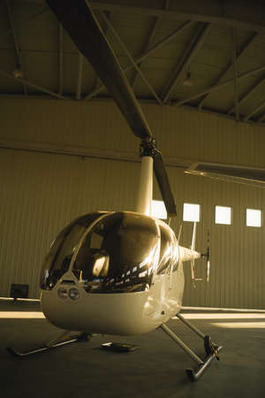 Helicopter parked in hangarの写真素材