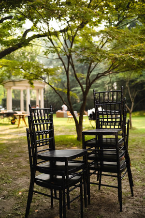 Table and chairs at a wedding ceremony in a garden. Selective focus.