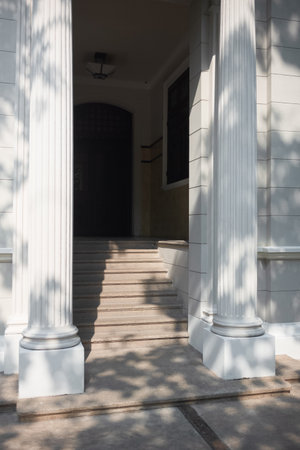 The entrance to the building with columns and sunlight in the morning.の写真素材