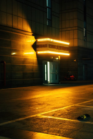 A street at night with a lighted building in the background.の写真素材