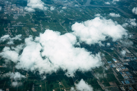 Aerial view of urban area with buildings and roads in the cloudsの写真素材