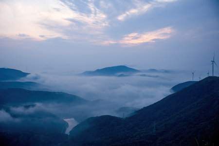 Landscape scenery view of a foggy mountain at sunrise in the morningの写真素材