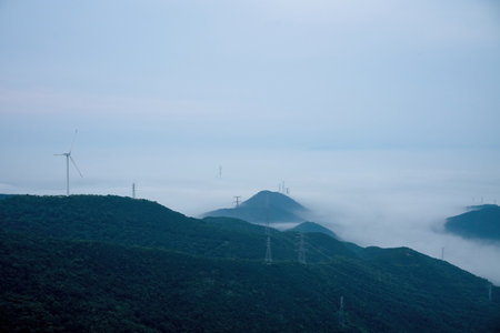 Wind turbines on the mountain with fog in the morning, north chinaの写真素材