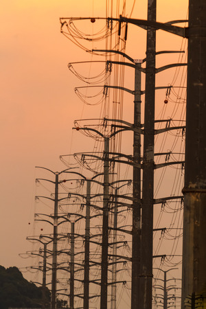 A Row of Transmission Towers during Sunsetの写真素材