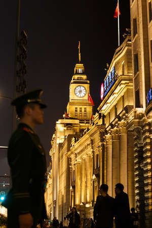 A China Soldier standing in attention position in  front of China Merchants Bank in The Bund,...