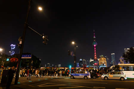 Oriental Pearl TV Tower night view with high human and car traffic from Waitan, Shanghai Chinaのeditorial素材