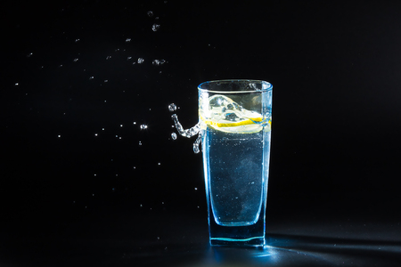 a glass of lemon waterの写真素材