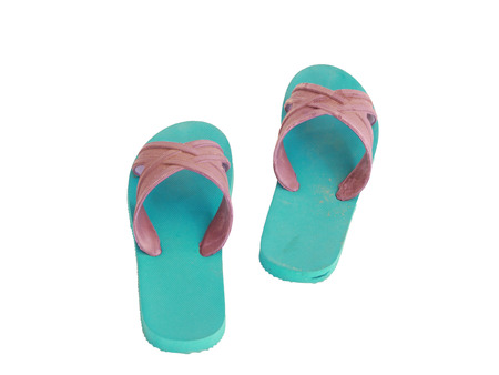 Green and blue rubber slippers on a white backgroundの写真素材