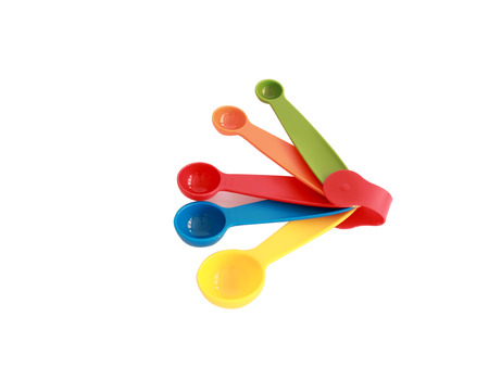 Colorful measuring spoons isolated on whiteの写真素材