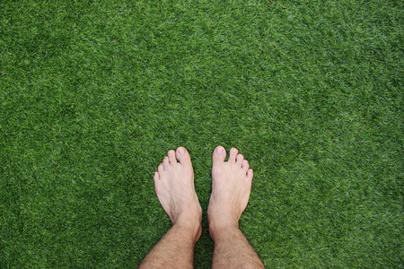 Two legs standing on green grass having fun outdoors in spring park