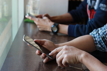 Close up of a man using mobile smart phoneの写真素材