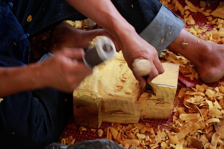 man carving in home