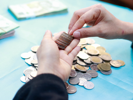 Young woman counting moneyの写真素材
