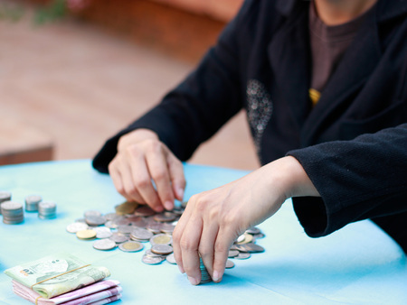 Young woman counting moneyの写真素材