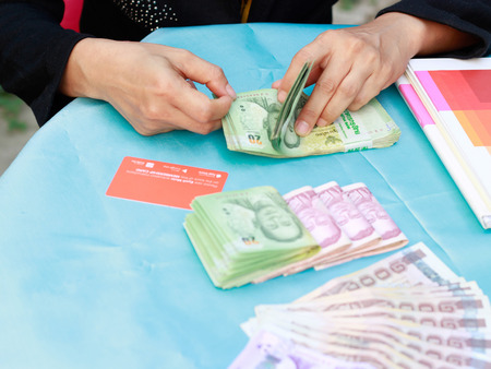 Young woman counting moneyの写真素材