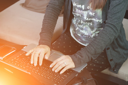 Woman typing with laptop.working at hotelの写真素材