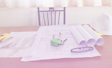 Blueprints, Construction level, Glasses, Hardhat, Measuring Tape, Pencil in architecture office retro style.の写真素材