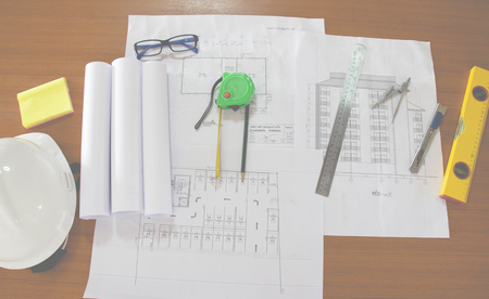 Blueprints, Construction level, Glasses, Hardhat, Measuring Tape, Pencil in architecture office retro style.の写真素材