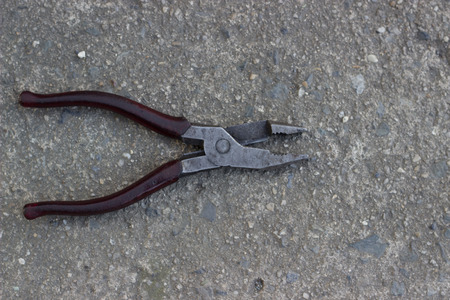 Black Red pliers on cement background.の写真素材