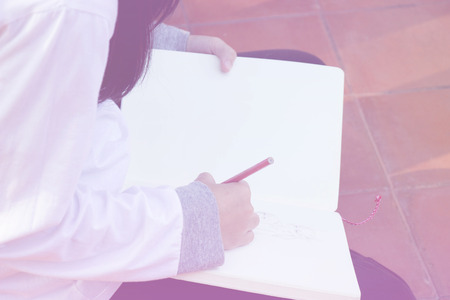 Teen girl Writing white bookの写真素材