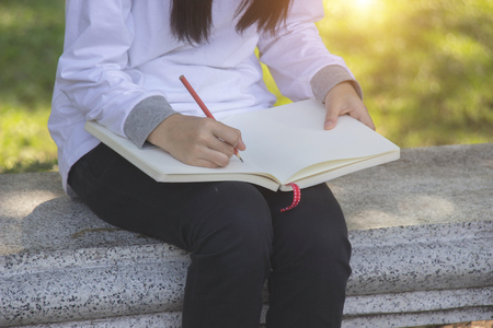 Teen girl Writing white bookの写真素材