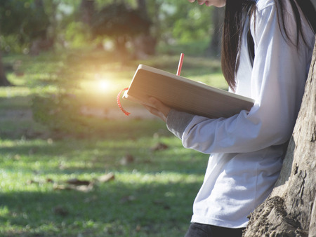 Teen girl open white book