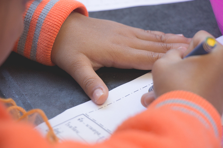 Children are drawing in paper on tableの写真素材