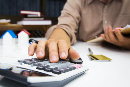 businessman using calculator and holding pen on tax paper in office.Accountingconcept.の写真素材