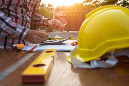 Engineer and Architect planing and discuss at Construction Site with blueprintの写真素材