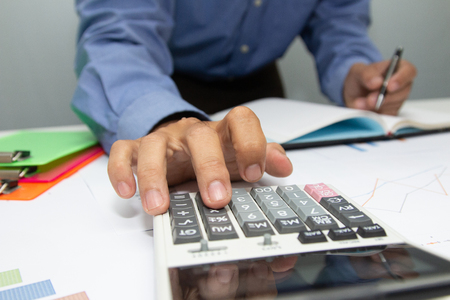 Business women are calculating the cost of running a public relations project for an organization.の写真素材