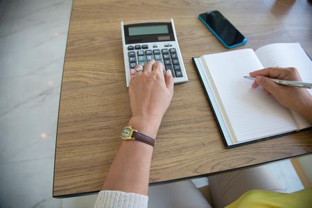 Business women using calculator for calculate tax in office.investments concept