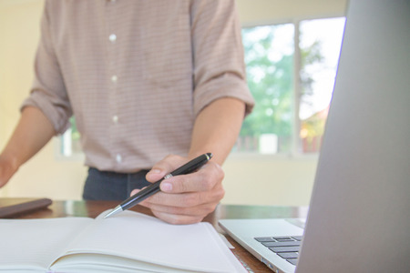 Businessman hand writing with document at work office.conceptの写真素材
