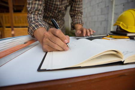 Architectural work site desk background construction project ideas concept, With drawing equipmen