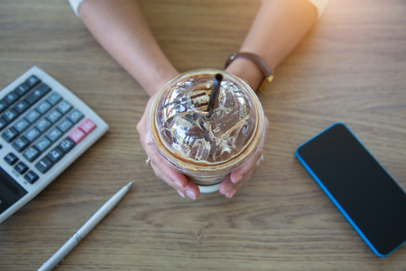Business women are searching for information on their competitors with mobile phones to plan their future investments.conceptの写真素材