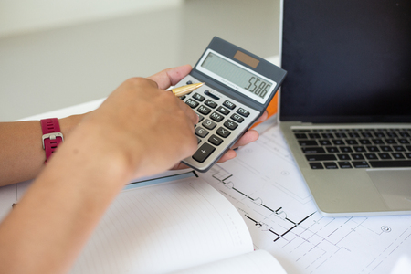 Businessmen are calculating budgets to invest in residential projects for customers.s.conceptの写真素材