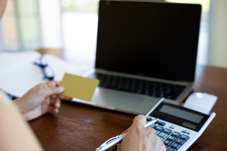 Hand women shoping online by notebook on desk about at coffee shop. shoping online conceptの写真素材