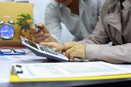 The business team is calculating and analyzing current online trading trends.の写真素材