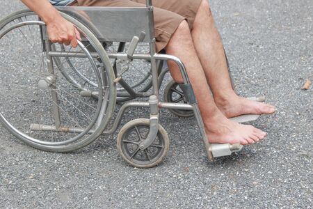 Disabled man is wheelchair at street.conceptの写真素材