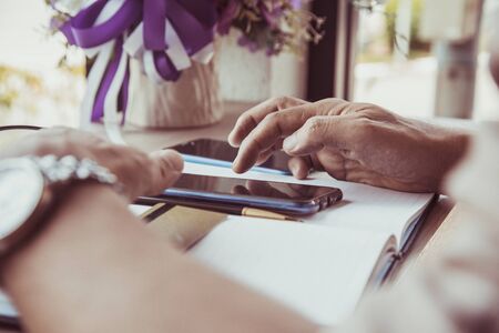 businessman hands searching for data on Notebook with analyzing charts at his workplace.の写真素材