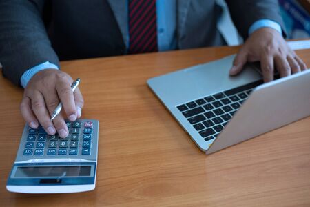 businessman hand using calculator for calculate tax in office.conceptの写真素材