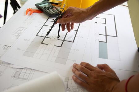 Engineers are writing home construction designs to bring them to prospective customers.の写真素材