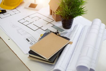 Desk of Architectural working solar panel home project in construction site,With drawing equipment...