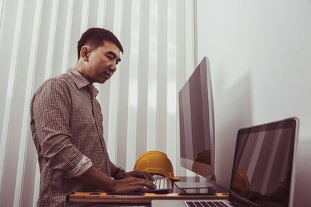 Architect Engineer Working with Blueprints in the office.の写真素材