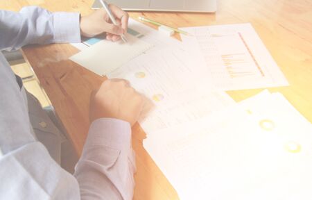 businessman working use laptop in office for discussing documents and ideas , with soft focus, vintage toneの写真素材