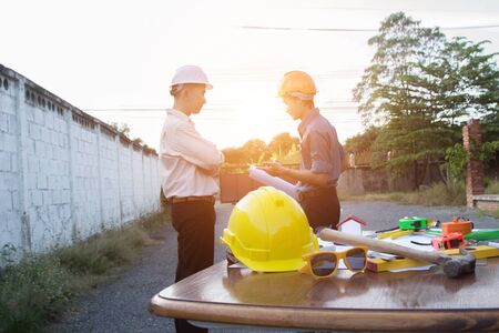Team of architects people in group on construction site check documents and business