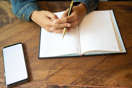 Businessman hand writing with document at work office.tax concept