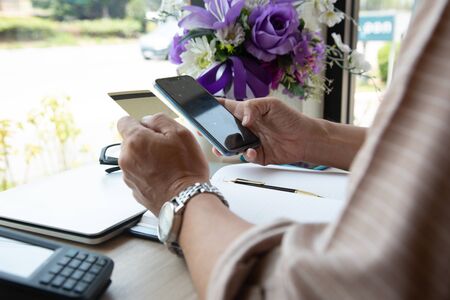 A businessmen scan cellphone on Card payments  via credit card machine in coffee shop, banking concept.business concept, soft focus, vintage toneの写真素材