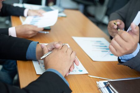 Closeup hand team business analysts make decisions about the US economy that affect future operations of the company.conceptの写真素材